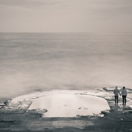 Holding hands by the sea